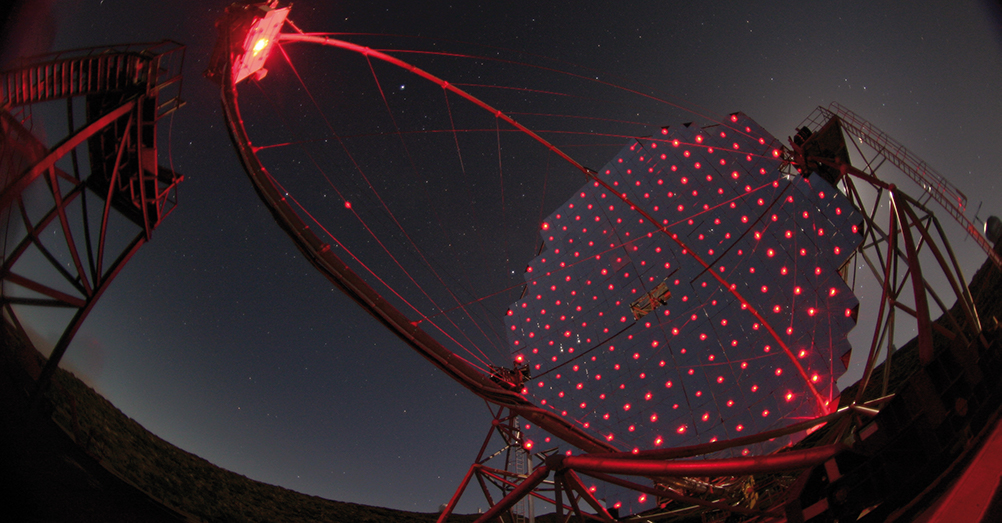 The MAGIC telescope with guidance lasers switched on.