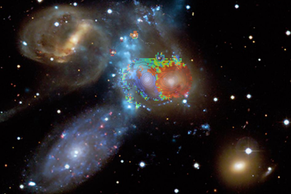 In this image, the blue, green and red colours in the central part indicate speeds derived from the WEAVE spectra and are superimposed on an image of Stephan's Quintet composed of starlight (from the CFHT telescope) and X-ray emission from hot gas (bluish vertical diffuse band, from the Chandra X-ray Observatory). The speeds obtained by WEAVE indicate that the left-centred galaxy (NGC 7318b, painted blue) is entering the group from behind at about 800 km/s (almost 3 000 000 km/h). This high-speed collision 
