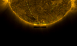 Photograph of the bottom half of the Sun, with a highlighted square region around the Sun's south pole. Taken in ultraviolet light, the image shows the hot gas in the Sun's outer atmosphere, the corona, glowing yellow as it extends outwards in threads and loops from the Sun.